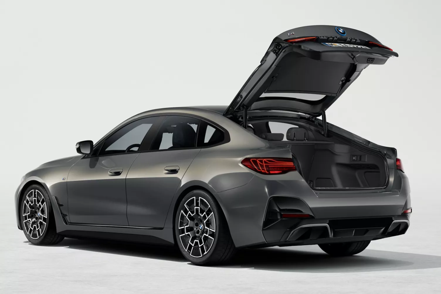 Gray BMW I4 . Open trunk BMW I4 . Electric BMW car . BMW I4 2024 . BMW dealership . BMW I4 performance . Luxury automobile . Electric luxury car . Buy BMW I4 . Test drive BMW I4 . BMW technology . BMW I4 design